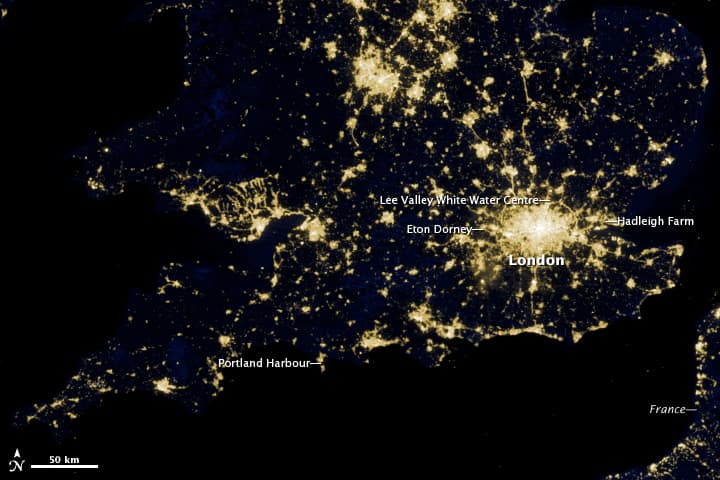 A satellite view of London at night showing city lights.